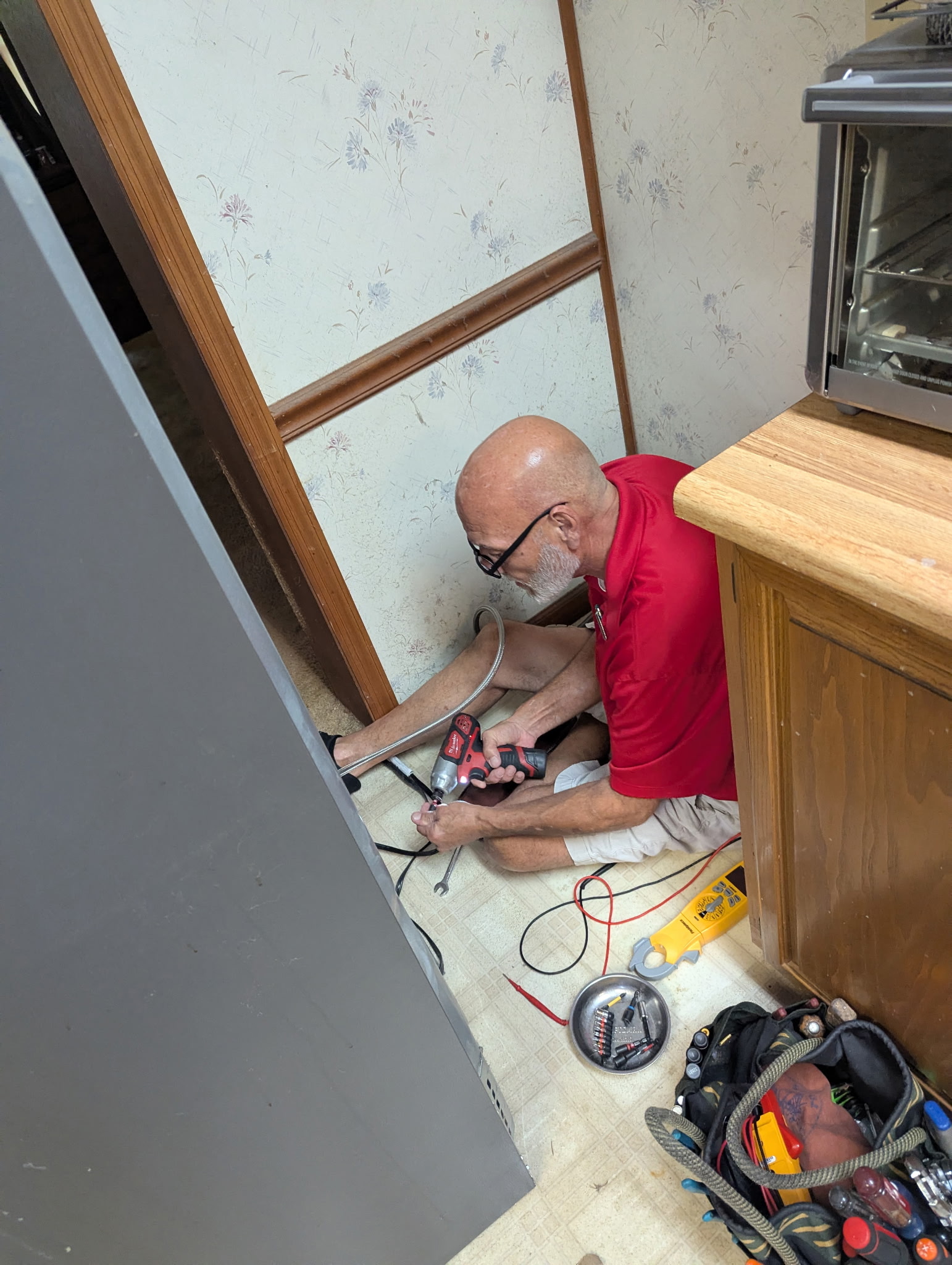 Brad Howard using professional tools during an in-home refrigerator repair