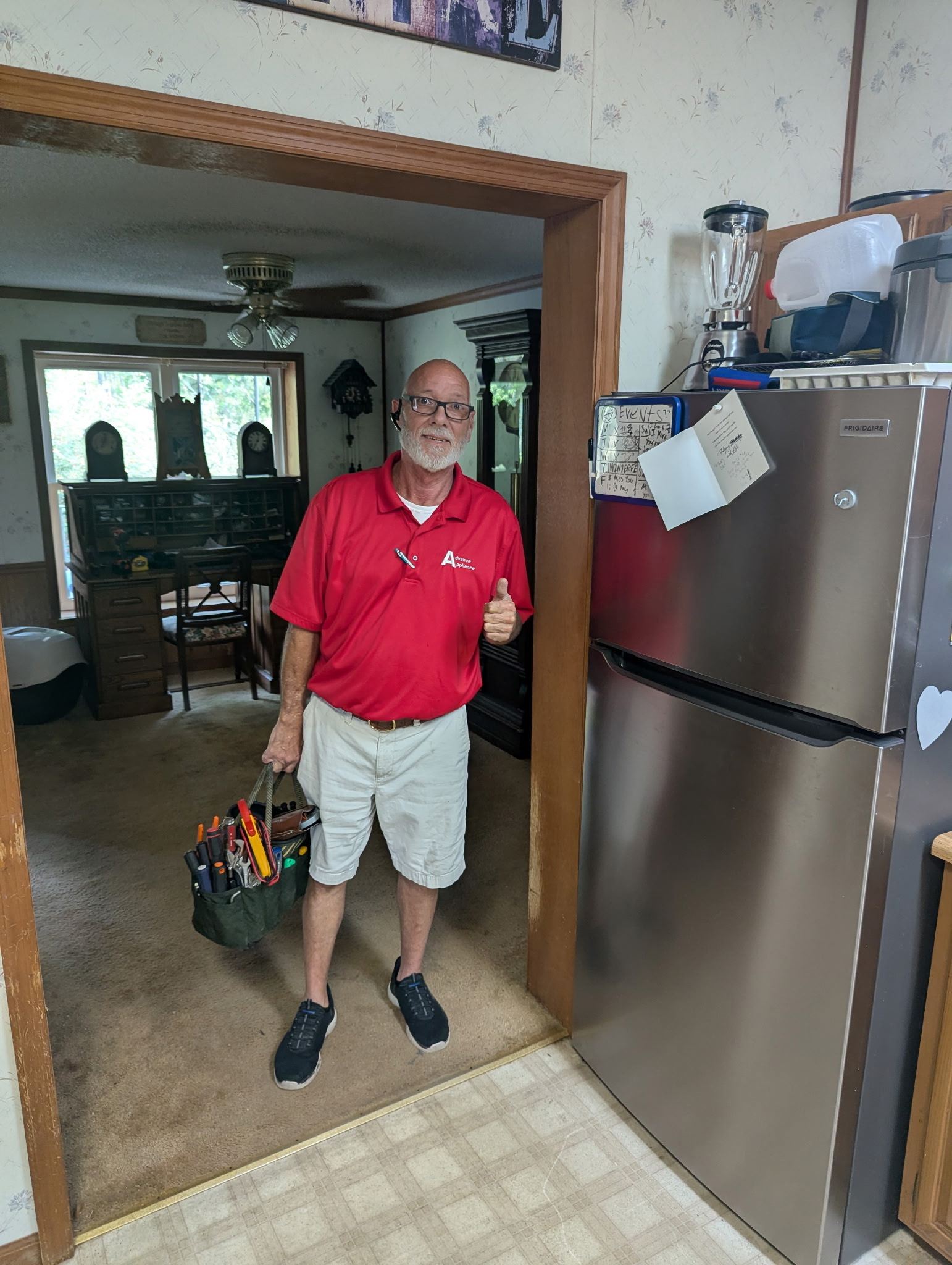 Brad Howard beside a refrigerator after completing an appliance service visit
